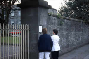 fig 3: Reading a text fly-posted outside of Saint Joseph's Mental Hospital.