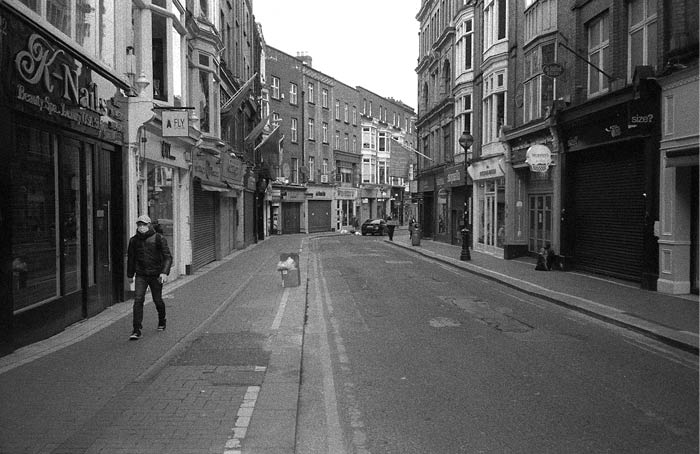 Fig. 10 Wicklow Street, Dublin. Usually a busy street with many restaurants and shops is abandoned at mid-day except for one solitary, masked human. April 2020.