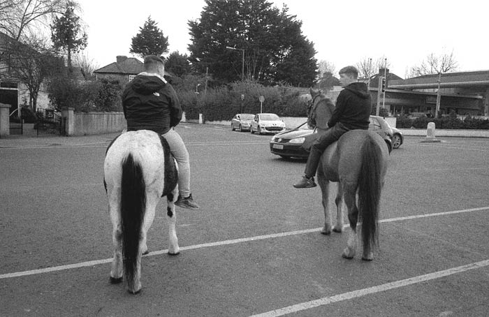 Fig. 17 Two men riding horses on the quiet lock-down streets in Cabra, Dublin. April 2021.