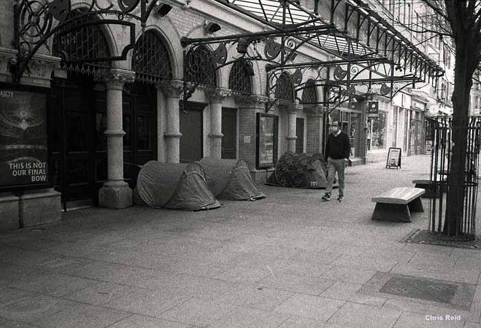 Fig. 20 A solitary man walks past tents occupied by homeless people on the otherwise deserted space outside the Gaiety Theatre, Dublin 2 during the Pandemic in December 2020