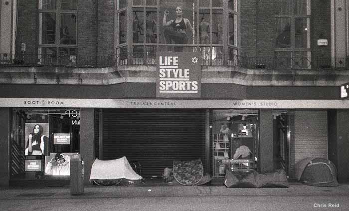 Fig. 24 Homeless people camp out in tents outside the closed front of Lifestyle Sports shops