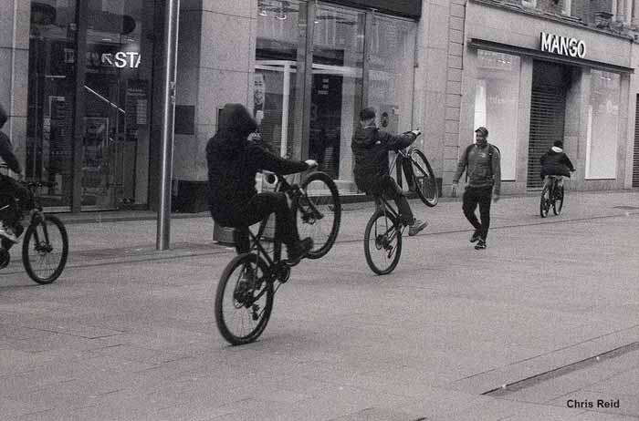 Fig. 25 Gangs of feral Children ride bikes wildly on Henry Street.