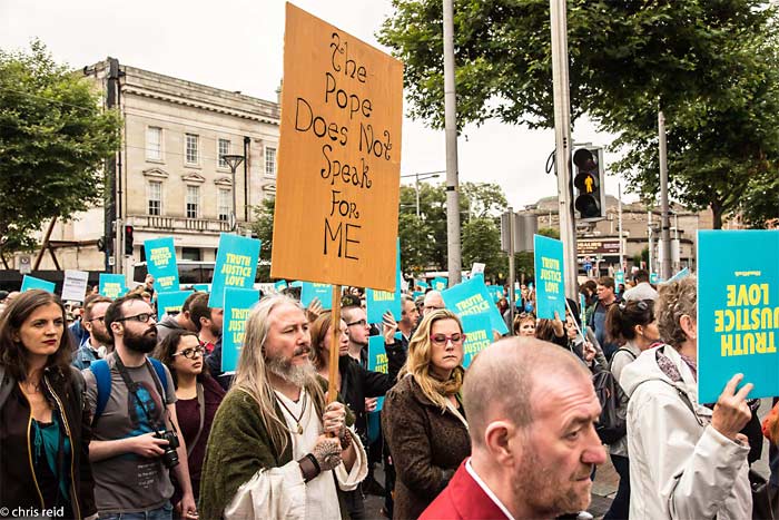 Fig.19 As the parade passed from O'Connell Street into Cathal Brugha Street. Jesus appears carrying a banner with the message, "The Pope does not speak for me".